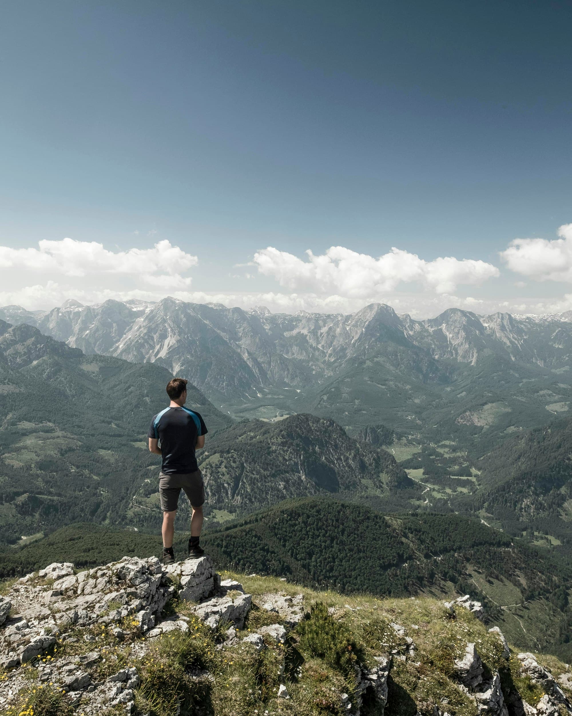 A hiker looking out across an alpine mountain range
